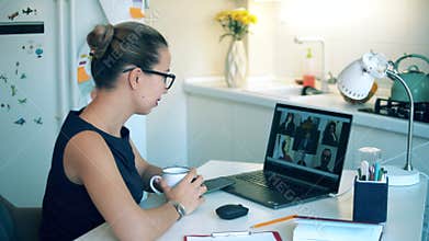 One worker videocalls via laptop, staying home during pandemic. Woman using video conferencing technology during covid