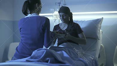 Caring woman visiting her sick friend at the hospital