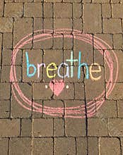 Breathe written in rainbow chalk