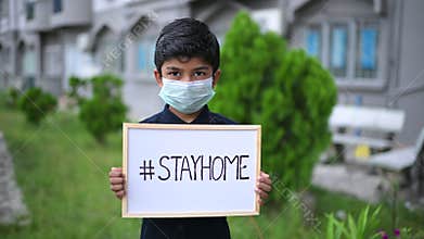 Stay at home .Coronavirus covid-19 infected.Asian Boy Wearing Masks and show drawing