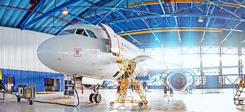 Panoramic view of aerospace hangar, civil aviation aircraft, repair and maintenance of mechanical parts in an industrial workshop