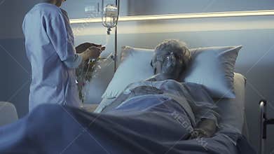 Professional nurse checking a senior patient at night