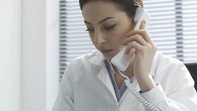 Female doctor giving a consultation on the phone