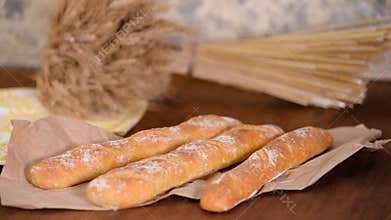 Freshly baked French baguettes on wooden table.
