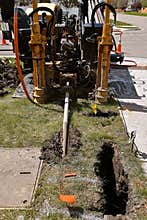 Machine for boring holes underground to bury cable lines