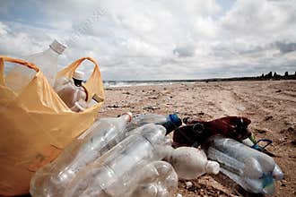 Pollution on beach â€“ plastic cans