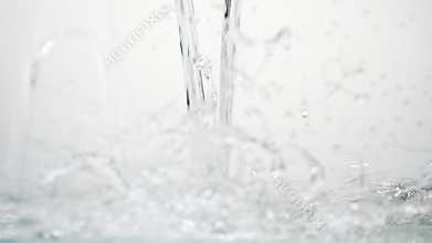 Side vie of pouring clear water in 180fps slow motion