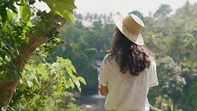 Girl traveler by the waterfall
