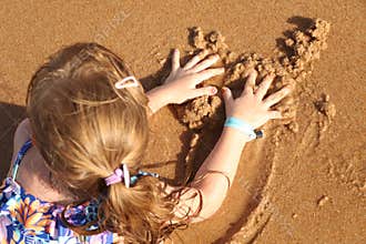 Girl playing on the beach with sand Covid - 19 Summer 2020