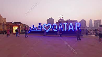 Porto Arabia  in The pearl Doha, Qatar sunset summer shot showing people walking on promenade