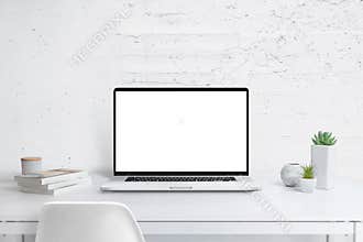 Modern laptop with isolated screen for mockup on office desk