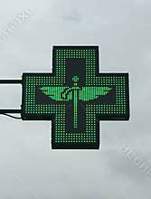 Green cross pharmacy store sign with caduceus. Pharmacy sign.