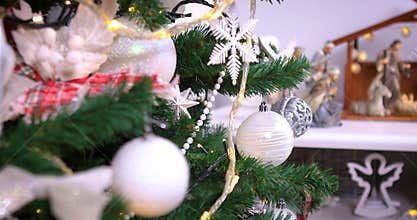 Jesus Christ birth Christmas scene with figures near Christmas tree