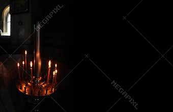 Candle light in dark in Christianity church
