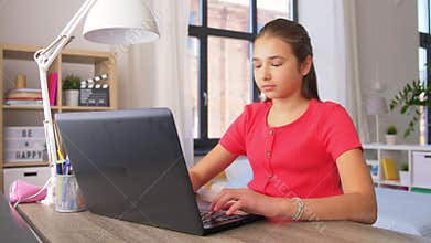 Student girl with laptop computer learning at home