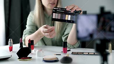 makeup beauty fashion blogger influencer recording video presenting cosmetics on social media at home
