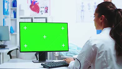 Physician writing diagnose on computer