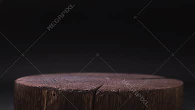 Dark wooden table for product presentation on black background