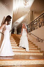 Two girls in a wedding dress on the stairs