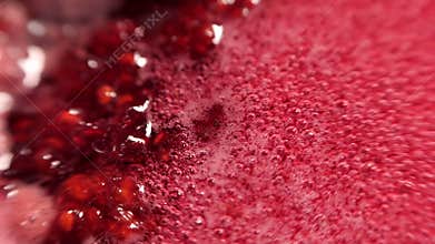 Raspberry syrup. Pink background with bubbling bubbles and raspberries.