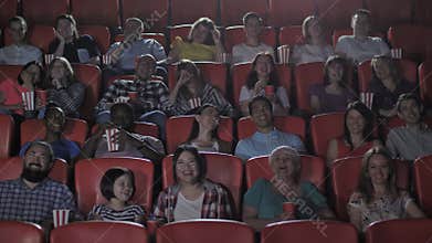Multinational viewers enjoying comedy in cinema