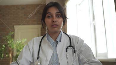 Indian female doctor talking to camera. Telemedicine in India concept