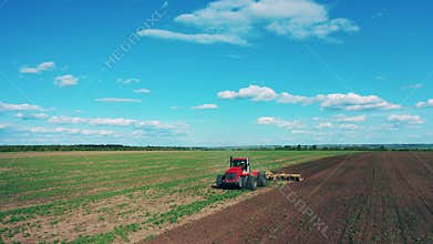 Agricultural tractor plows ground for seeds planting.