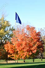 Golf Flag and Flagstick with Colorful Fall Leaves