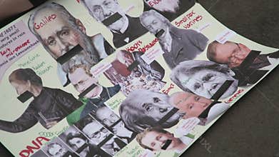 A sign with famous scientists rest on the Ground at the NYC March for Science