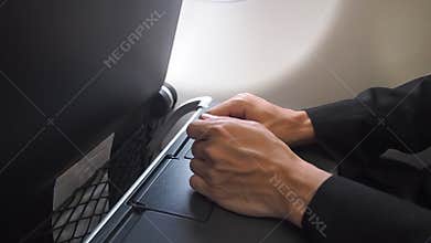 Nervous male passenger hand shaking when sitting in aircraft. Symptom on plane phobia.