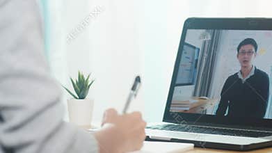 Young Asia teen girl university student using laptop computer distance learning lesson with male teacher remote