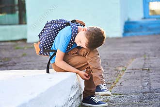 Schoolboy is depressed. back to school. the first autumn day. the child is not in school. apathy no friends in the new school.