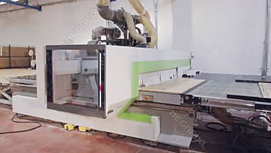 Automated wood processing machine in a furniture manufacturing facility