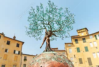 Bronze sculpture of the Tree of Life in the Amphitheater square in old town Lucca, Tuscany, Italy