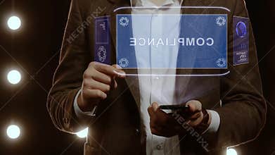 Businessman shows hologram with text Compliance