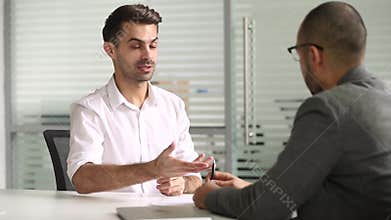 Male salesman talking with client handshaking closing deal at meeting