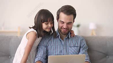 Father and daughter having fun listening music online use computer
