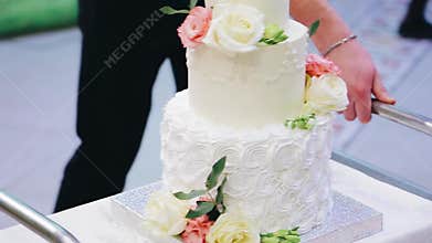 A stunning wedding cake is brought on a cart. Holiday. Nice shots.