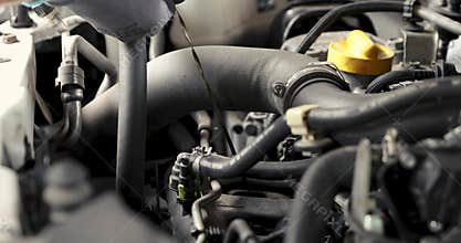 Mechanic`s hand pulling out car engine oil level dip stick