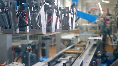 Modern factory equipment. Robotic mechanism is relocating carton boxes and packing them