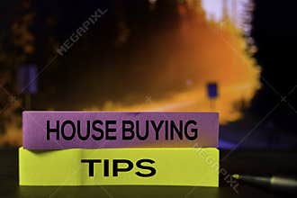 House Buying Tips on the sticky notes with bokeh background