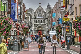 Dublin, Ireland Grafton Street Mall.  Brilliant colors of shoppers and shops highlight this photo. 