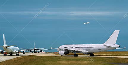 Busy airport, airplanes  in runway queue