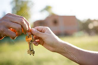 Realtor giving house key yo new owner
