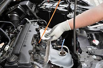 Man checking oil level in Honda CR-V car engine
