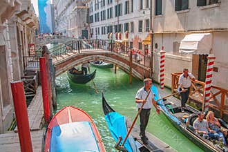 Tourists sightseeing in gondola in Venice canal