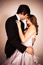 Attractive Young Couple Embracing For A Kiss