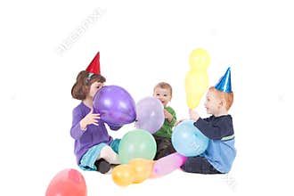 Happy kids playing with balloons at party