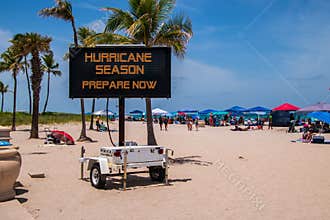 This is a sign on a beach on a hot summer day warning that it is hurricane season and that