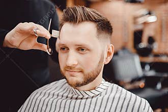 Barbershop, man barber in men hairdresser does hair with scissors